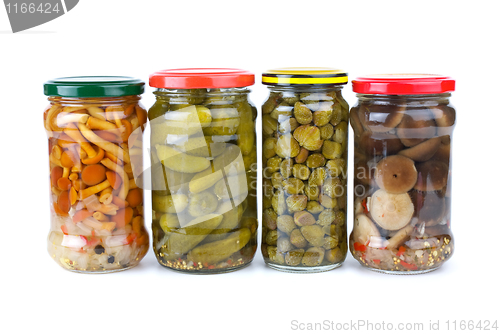 Image of Glass jars with marinated cornichons, mushrooms and capers