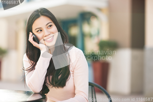 Image of Asian woman on the phone