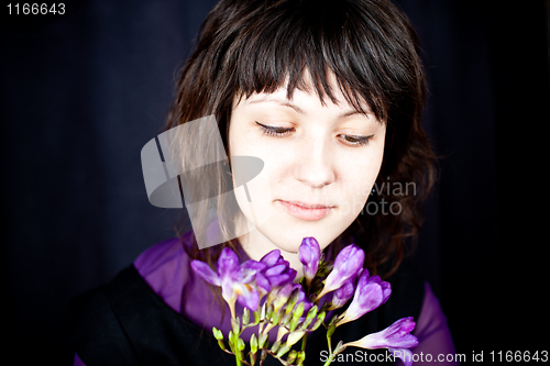 Image of beautiful woman with purple flowers