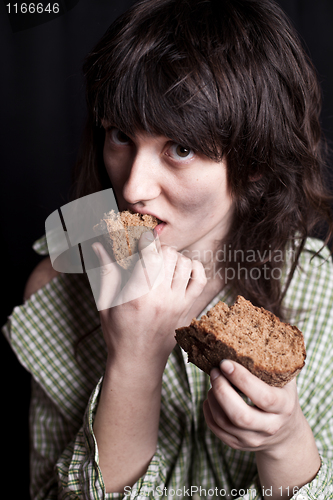 Image of beggar woman eating bread 