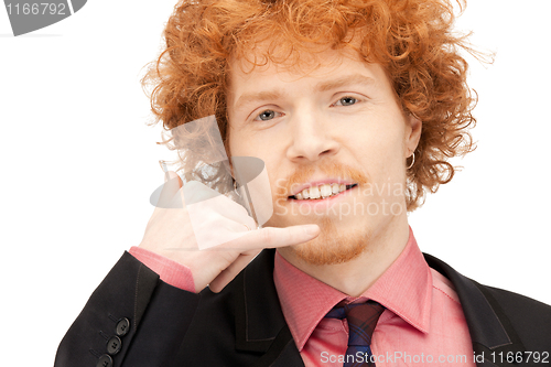 Image of man making a call me gesture