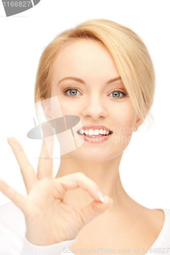 Image of lovely teenage girl showing ok sign