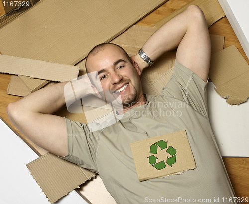 Image of caucasian man and recycling paper