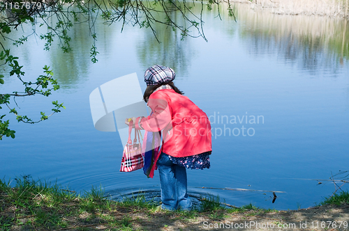 Image of Happy Cute Little Girl At A Lake