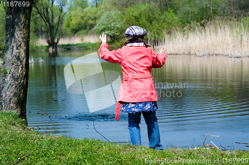 Image of Happy Cute Little Girl At A Lake
