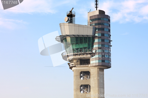 Image of air traffic control tower at an airport on a stormy looking day.