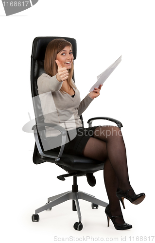 Image of beautiful girl is sitting in an office chair