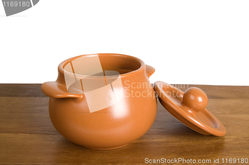 Image of Ceramic pot on the wooden board