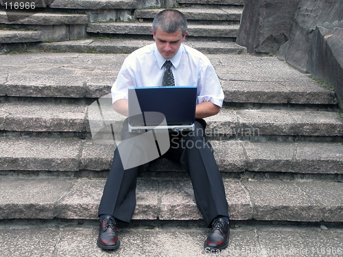 Image of Businessman with laptop outdoor