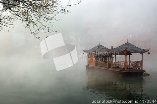 Image of China landscape of boat on foggy river