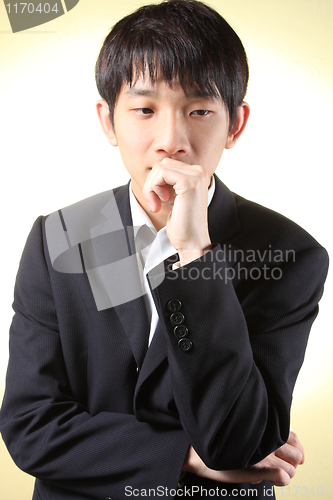 Image of Businessman thinking wearing a suit