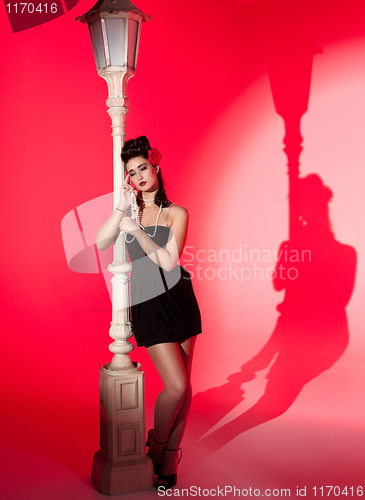 Image of young woman and lightpole