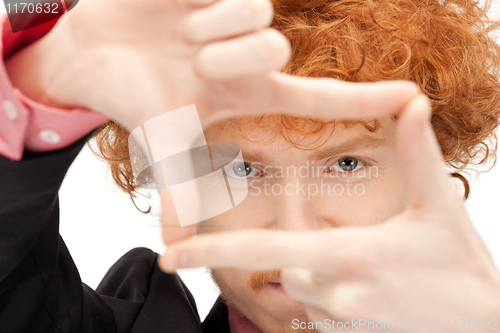 Image of handsome man creating a frame with fingers