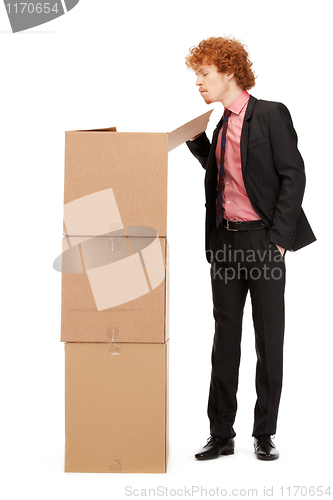 Image of attractive businessman with big boxes