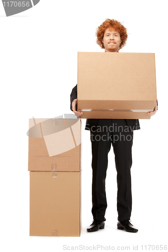 Image of attractive businessman with big boxes