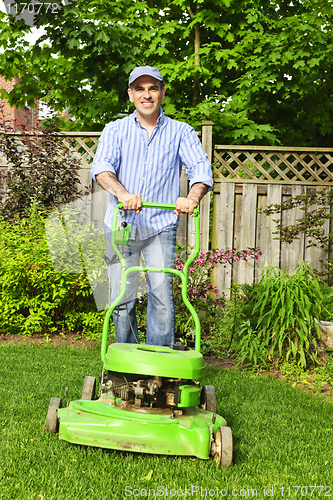 Image of Man mowing lawn