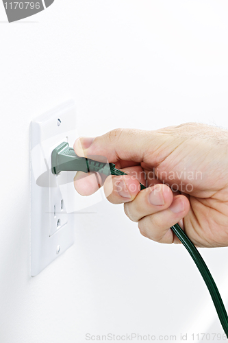 Image of Hand removing plug from outlet