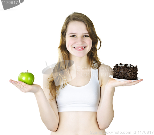 Image of Young girl holding apple and cake