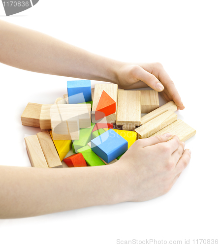 Image of Hands with wooden block toys