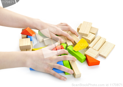Image of Hands with wooden block toys