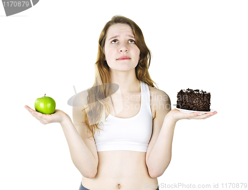 Image of Young girl holding apple and cake