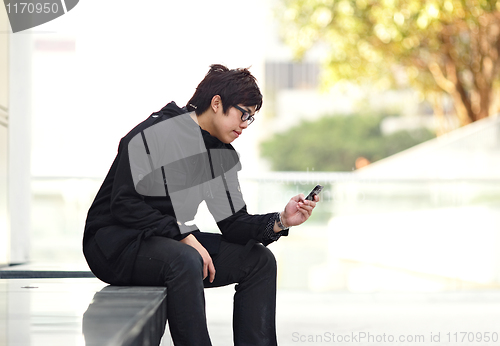 Image of man sms on cell phone