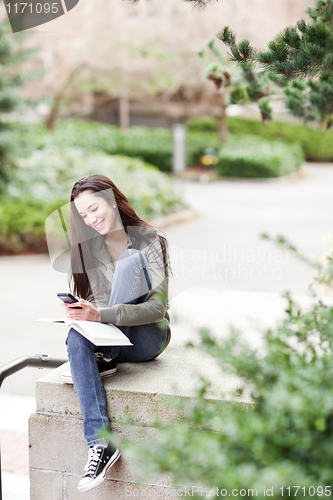 Image of Ethnic student texting