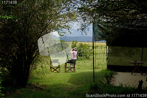 Image of Woman by safari tent on Masai Mara