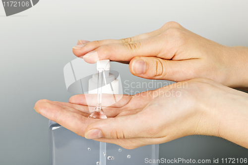 Image of Hands applying sanitizer gel