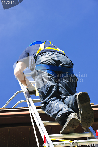 Image of Construction worker climbing ladder