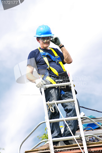 Image of Man working on roof