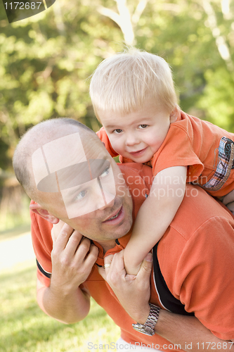 Image of Father and Son Piggyback in the Park