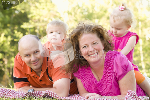 Image of Happy Young Family with Twins Portrait in Park