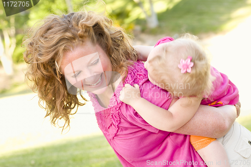 Image of Mother and Daughter Piggyback in the Park