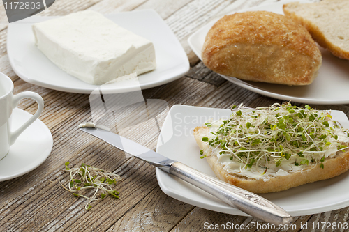 Image of roll with cream cheese and sprouts