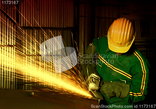 Image of heavy industry manual worker with grinder