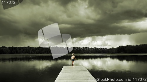 Image of Boy standing on a Footbridge