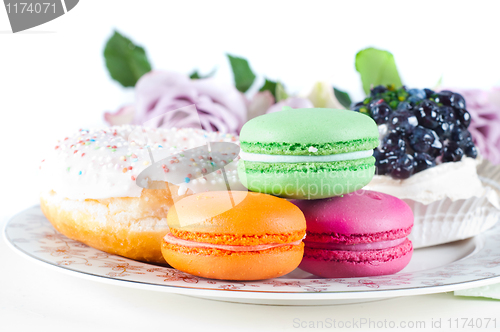 Image of Sweets and roses on the table