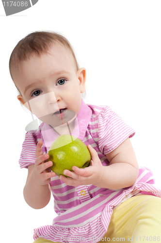 Image of Baby girl in pink eating apple