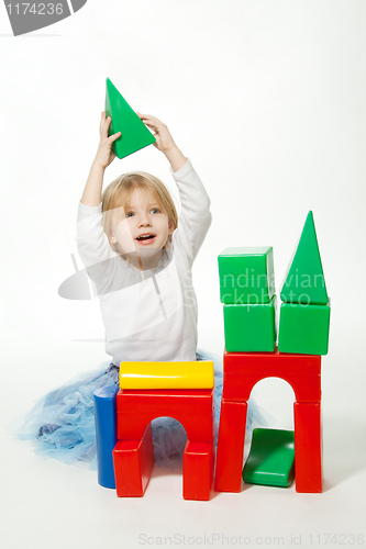 Image of Blond little girl building house