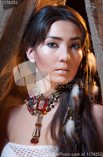 Image of Portrait of American Indian female looking from tent