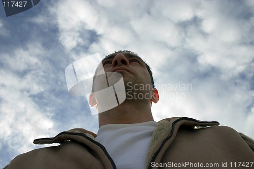 Image of Man Looking up with the Clouds on the Background