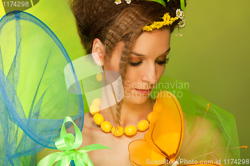 Image of Summer girl catching butterfly with butterfly net