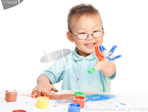Image of Chinese boy painting with hands