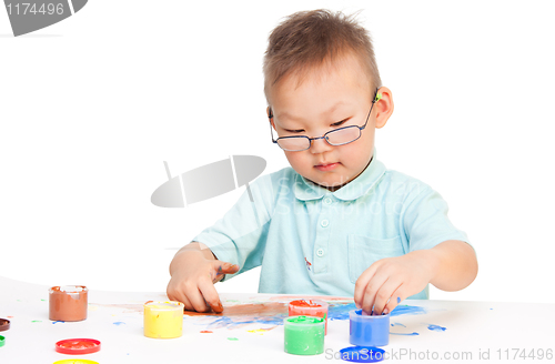 Image of Little boy painting