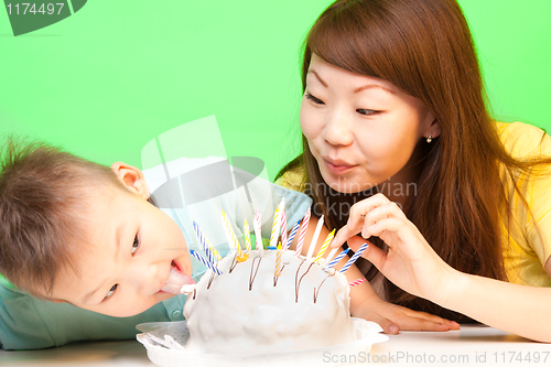 Image of Boy licks his birthday cake