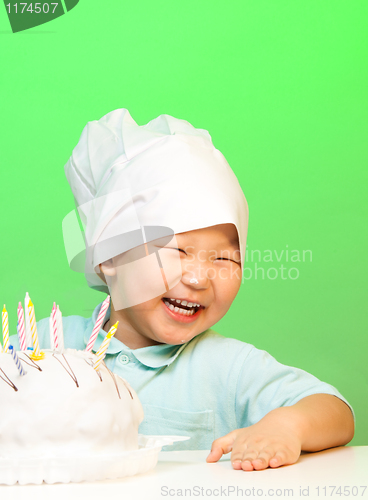 Image of Happy boy with just cooked cake