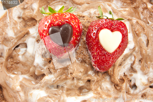 Image of Two strawberries with chocolate hearts - high dof