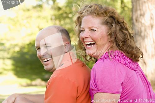 Image of Happy Attractive Couple Laughing in Park