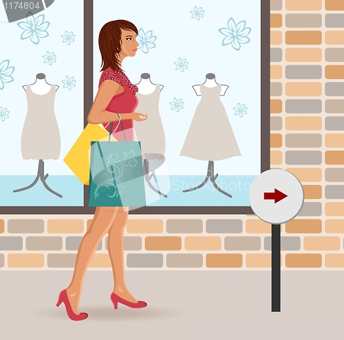 Image of modern girl loaded with shopping bags